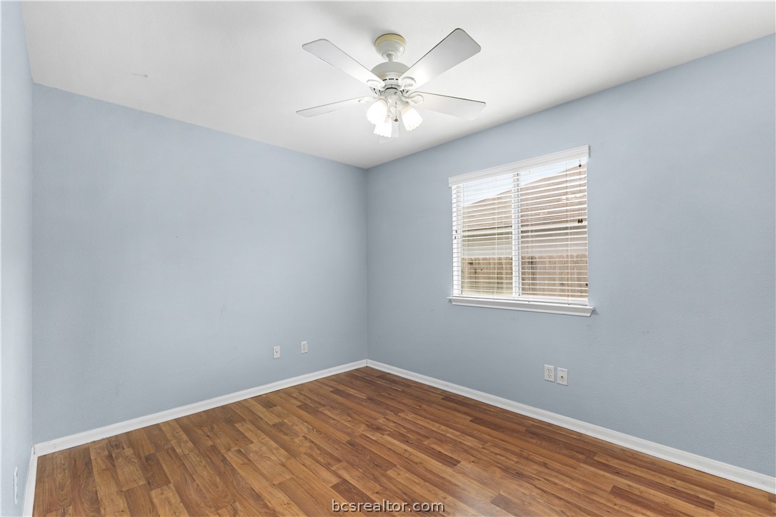 3709 Springfield Drive College Station, TX 77845 - Photo 17 of 23 an empty room with wooden floor chandelier fan and windows