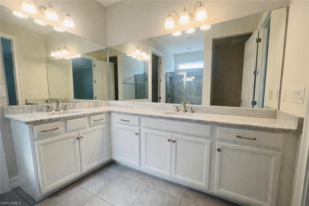 28442 Captiva Shell Loop Bonita Springs, FL 34135 - Photo 14 of 35 a bathroom with a double vanity sink and a mirror