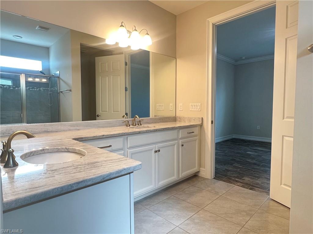 28442 Captiva Shell Loop Bonita Springs, FL 34135 - Photo 15 of 35 a bathroom with a granite countertop sink and a mirror