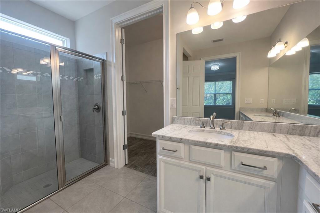 28442 Captiva Shell Loop Bonita Springs, FL 34135 - Photo 16 of 35 a bathroom with a sink double vanity and a mirror