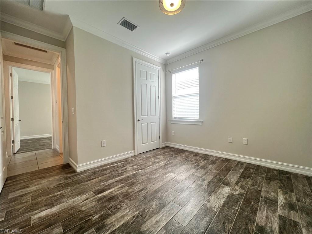 28442 Captiva Shell Loop Bonita Springs, FL 34135 - Photo 17 of 35 an empty room with wooden floor and windows
