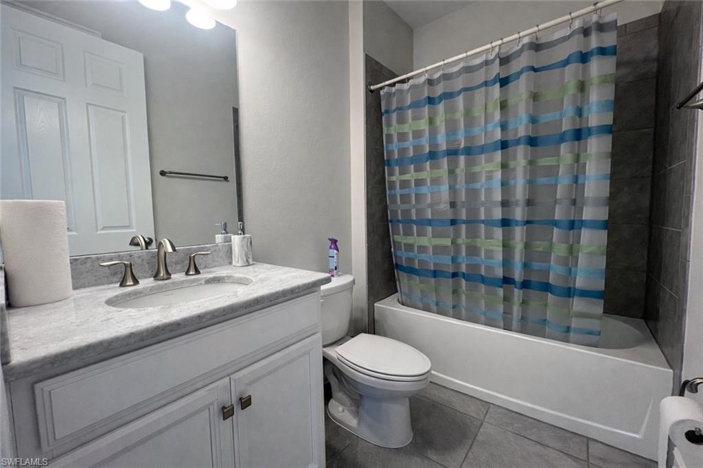 28442 Captiva Shell Loop Bonita Springs, FL 34135 - Photo 18 of 35 a bathroom with a granite countertop bathtub sink vanity mirror and toilet