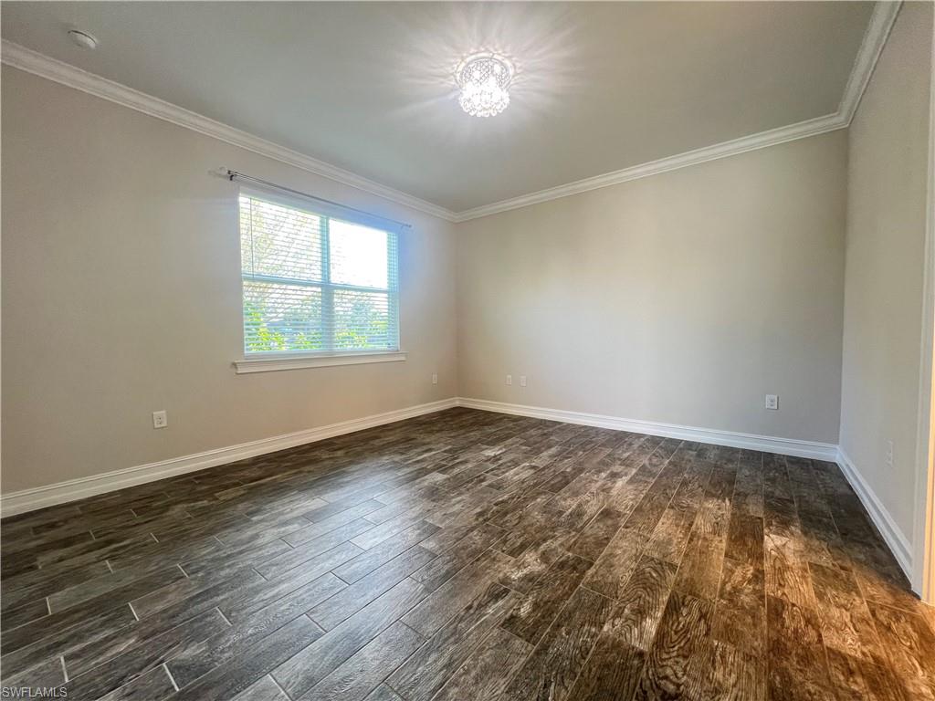 28442 Captiva Shell Loop Bonita Springs, FL 34135 - Photo 19 of 35 an empty room with wooden floor and windows