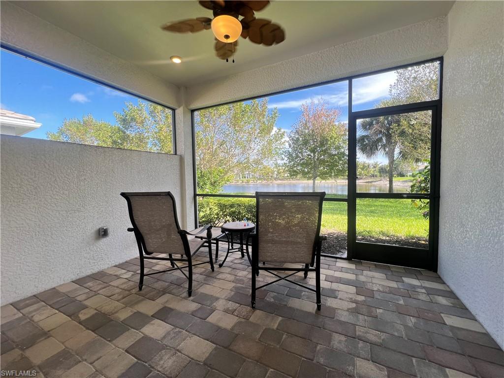 28442 Captiva Shell Loop Bonita Springs, FL 34135 - Photo 21 of 35 a view of a dining room with furniture large windows and wooden floor