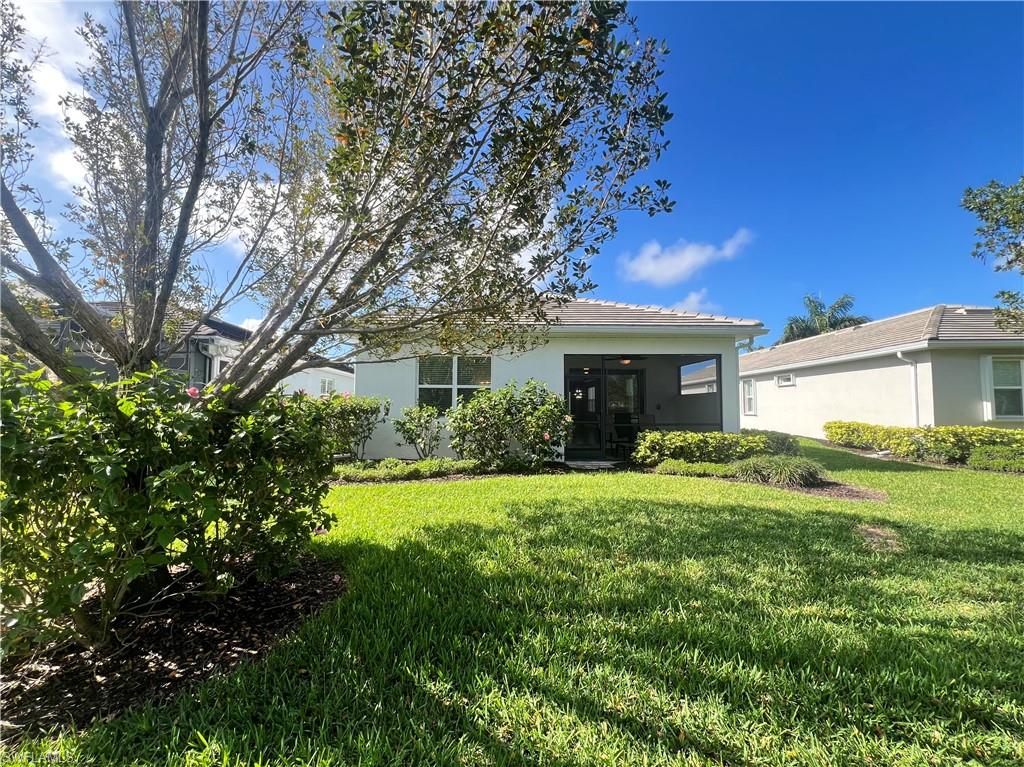 28442 Captiva Shell Loop Bonita Springs, FL 34135 - Photo 24 of 35 a front view of a house with a garden