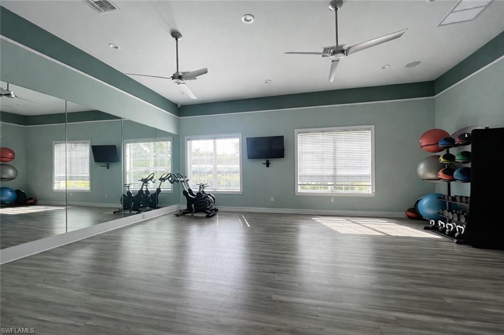 28442 Captiva Shell Loop Bonita Springs, FL 34135 - Photo 32 of 35 a view of a livingroom with hardwood floor and a ceiling fan