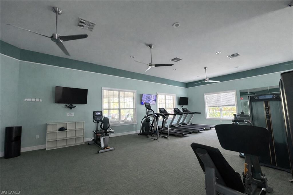 28442 Captiva Shell Loop Bonita Springs, FL 34135 - Photo 34 of 35 a living room with furniture and a flat screen tv