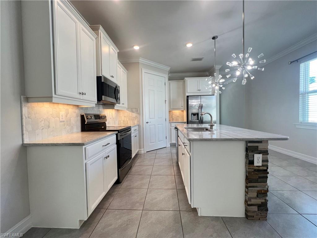 28442 Captiva Shell Loop Bonita Springs, FL 34135 - Photo 6 of 35 a kitchen with a sink stove and microwave