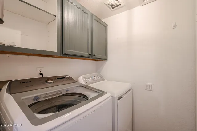 a kitchen with stainless steel appliances a refrigerator sink and cabinets