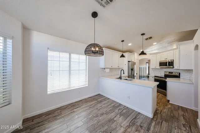 a view of a kitchen with windows