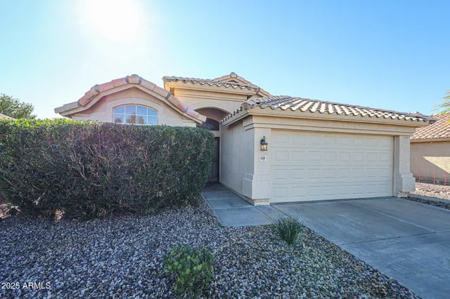 a view of a house with a yard and garage