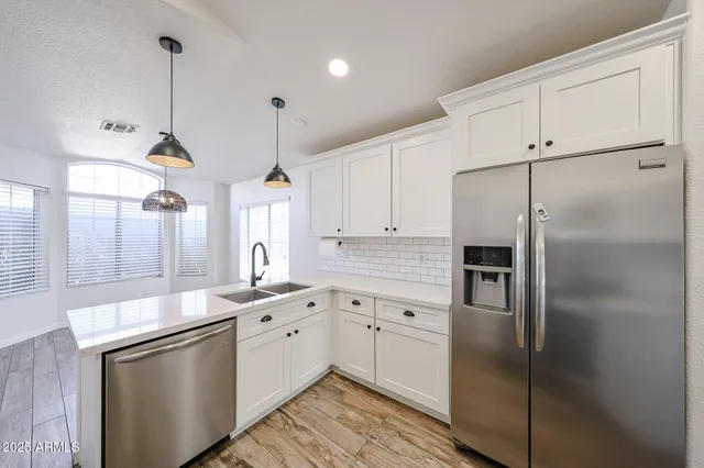 a kitchen with a sink appliances and cabinets