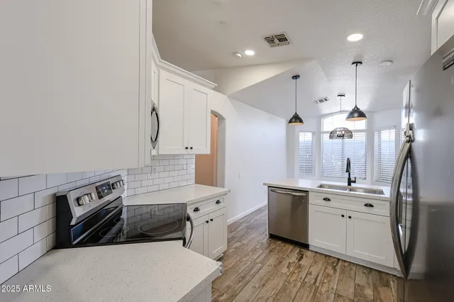 en empty room with wooden floor and fan