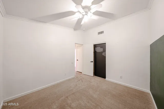 a view of a room with a ceiling fan and a window