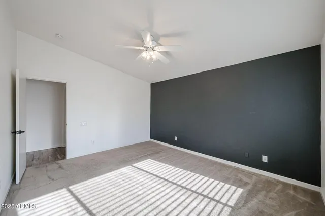 a view of a room with a ceiling fan and a window