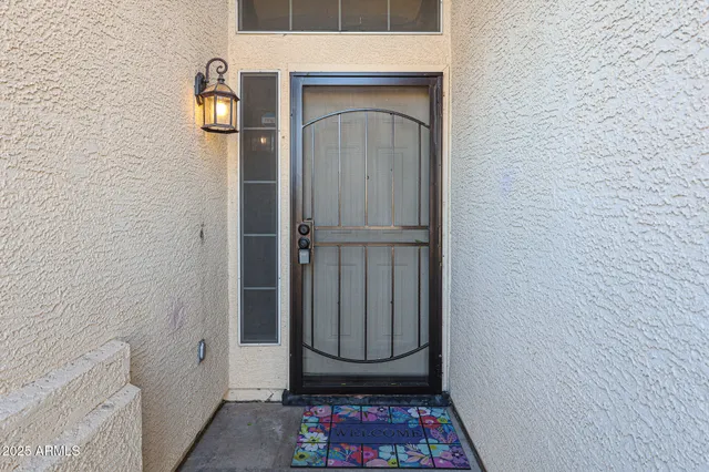 a view of a hallway with wooden floor and a bathroom