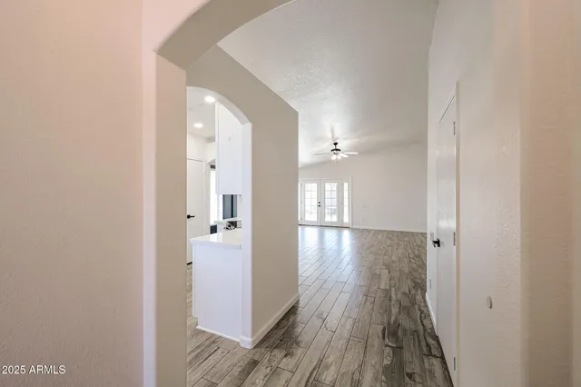 a view of a kitchen with a closet and wooden floor