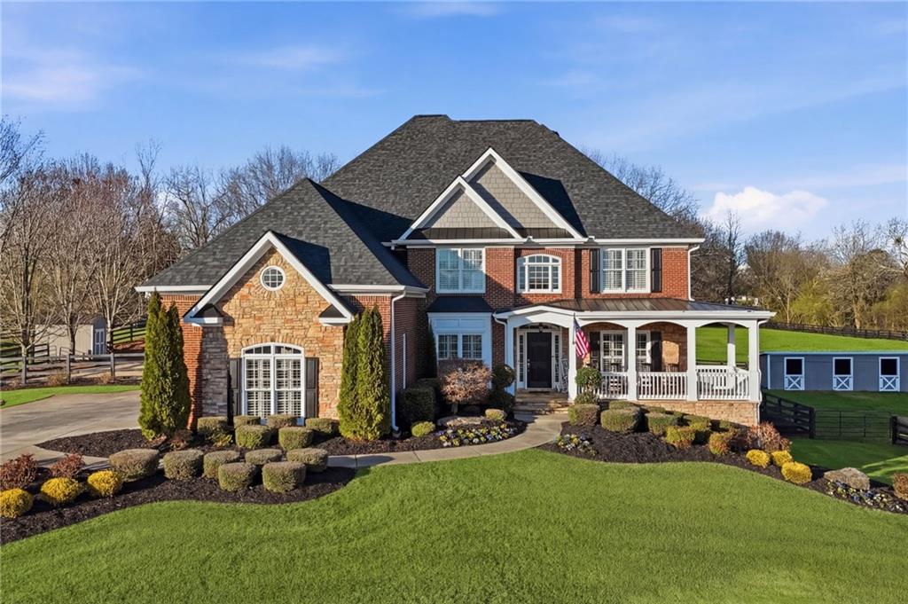 a front view of a house with a garden and plants