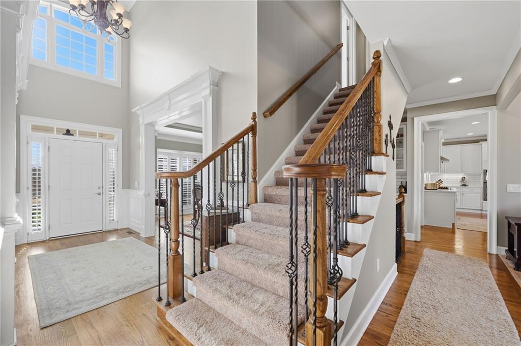 140 Red Gate Lakes Drive Canton, GA 30115 - Photo 11 of 92 a view of a hallway with wooden floor and staircase
