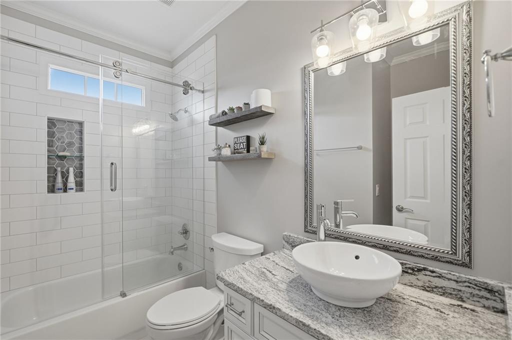 140 Red Gate Lakes Drive Canton, GA 30115 - Photo 12 of 92 a bathroom with a granite countertop sink toilet a mirror and shower