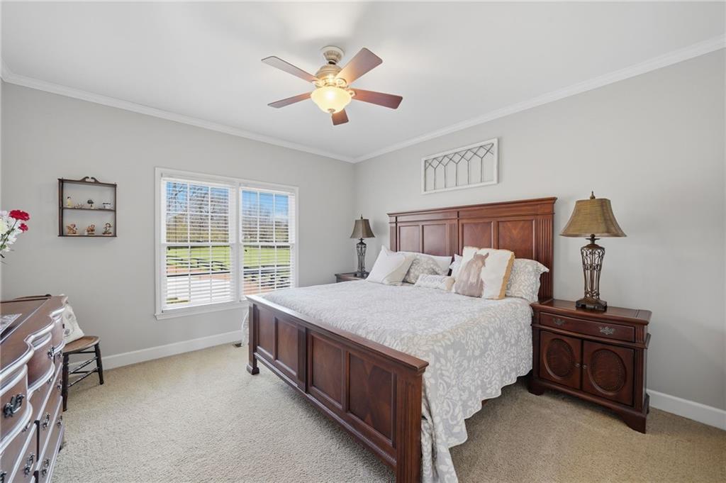 140 Red Gate Lakes Drive Canton, GA 30115 - Photo 13 of 92 a bedroom with a bed chandelier and a window