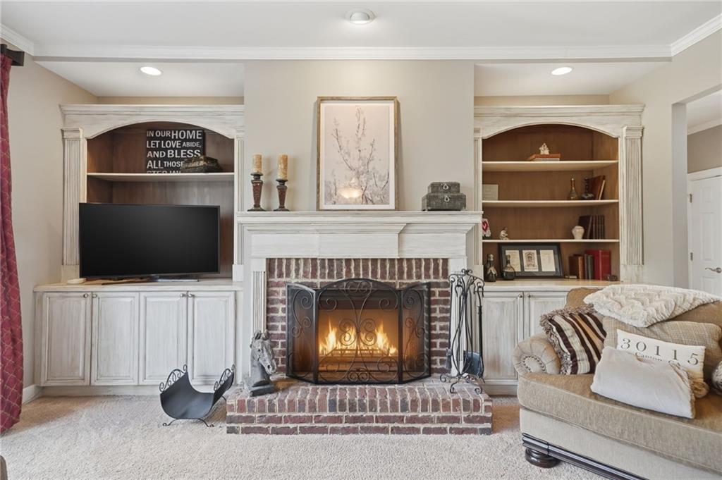 140 Red Gate Lakes Drive Canton, GA 30115 - Photo 17 of 92 a living room with furniture a flat screen tv and a fireplace