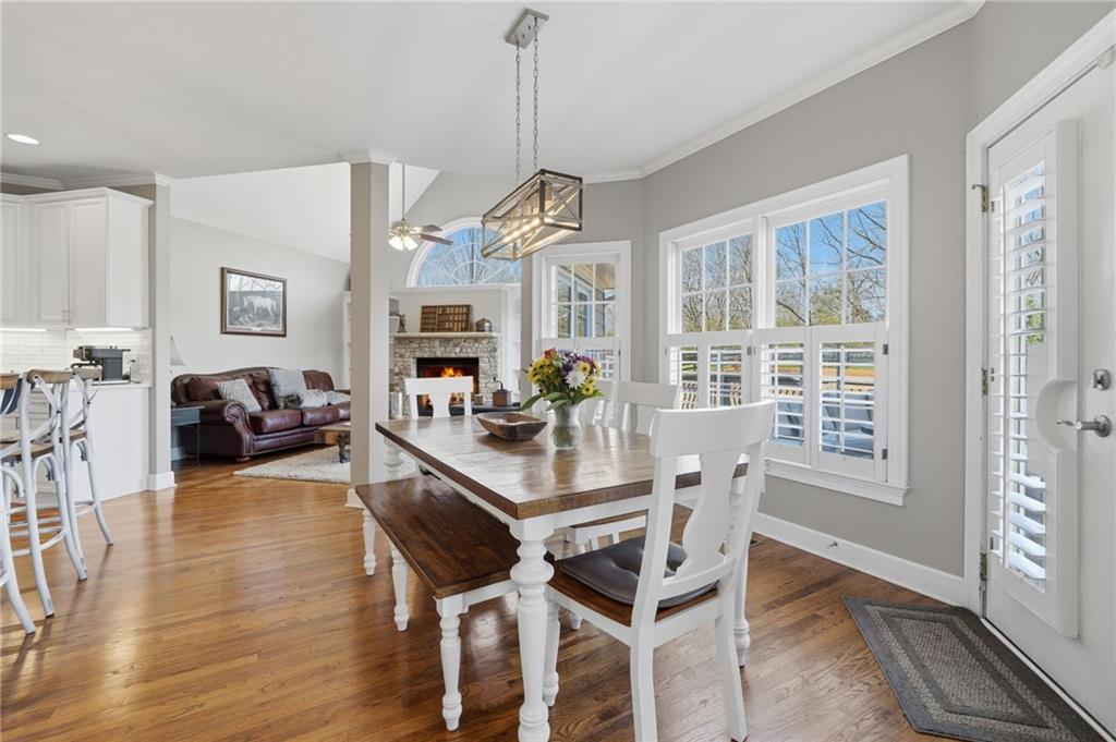 140 Red Gate Lakes Drive Canton, GA 30115 - Photo 18 of 92 a dining room with wooden floor a chandelier a wooden table and chairs
