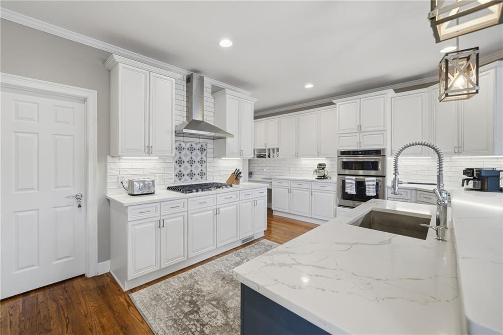 140 Red Gate Lakes Drive Canton, GA 30115 - Photo 27 of 92 a kitchen with kitchen island granite countertop a sink cabinets and stainless steel appliances