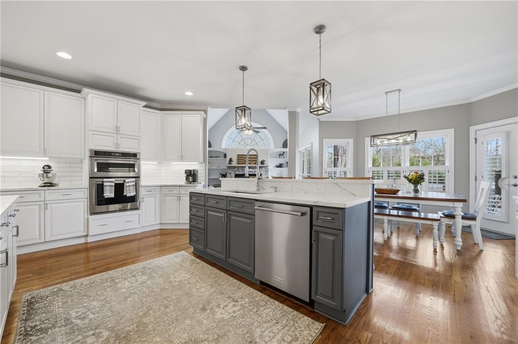 140 Red Gate Lakes Drive Canton, GA 30115 - Photo 28 of 92 a kitchen with stainless steel appliances granite countertop a sink a stove top oven a counter space and cabinets