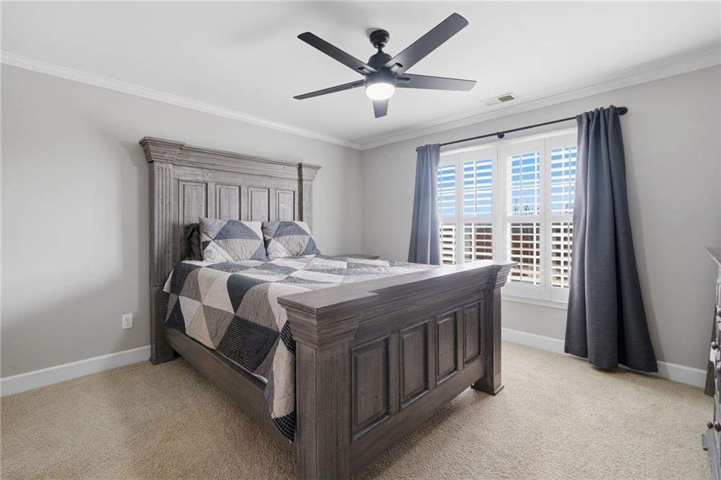 140 Red Gate Lakes Drive Canton, GA 30115 - Photo 37 of 92 a spacious bedroom with a bed and a large window