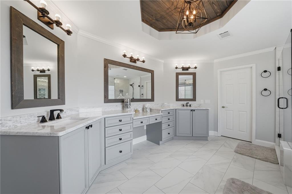 140 Red Gate Lakes Drive Canton, GA 30115 - Photo 47 of 92 a spacious bathroom with a double vanity sink a mirror a window and a bathtub