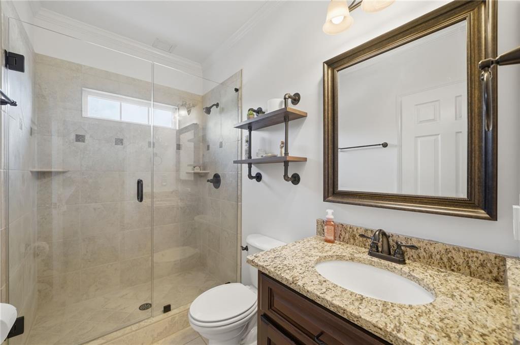 140 Red Gate Lakes Drive Canton, GA 30115 - Photo 51 of 92 a bathroom with a granite countertop sink a toilet and shower