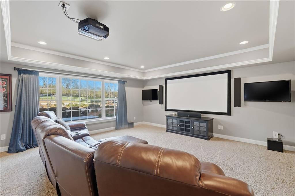 140 Red Gate Lakes Drive Canton, GA 30115 - Photo 55 of 92 a living room with furniture a projector and a flat screen tv