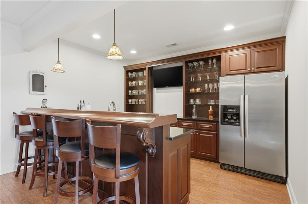 140 Red Gate Lakes Drive Canton, GA 30115 - Photo 60 of 92 a kitchen with stainless steel appliances kitchen island granite countertop a refrigerator a stove a sink with island chairs and wooden floor