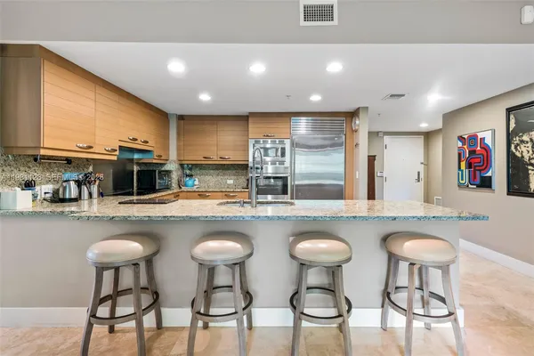 a kitchen with lots of counter space and chairs