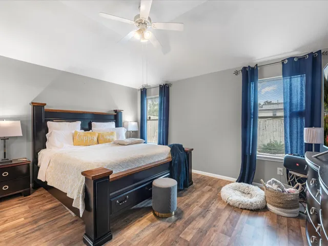 a bedroom with a bed and wooden floor