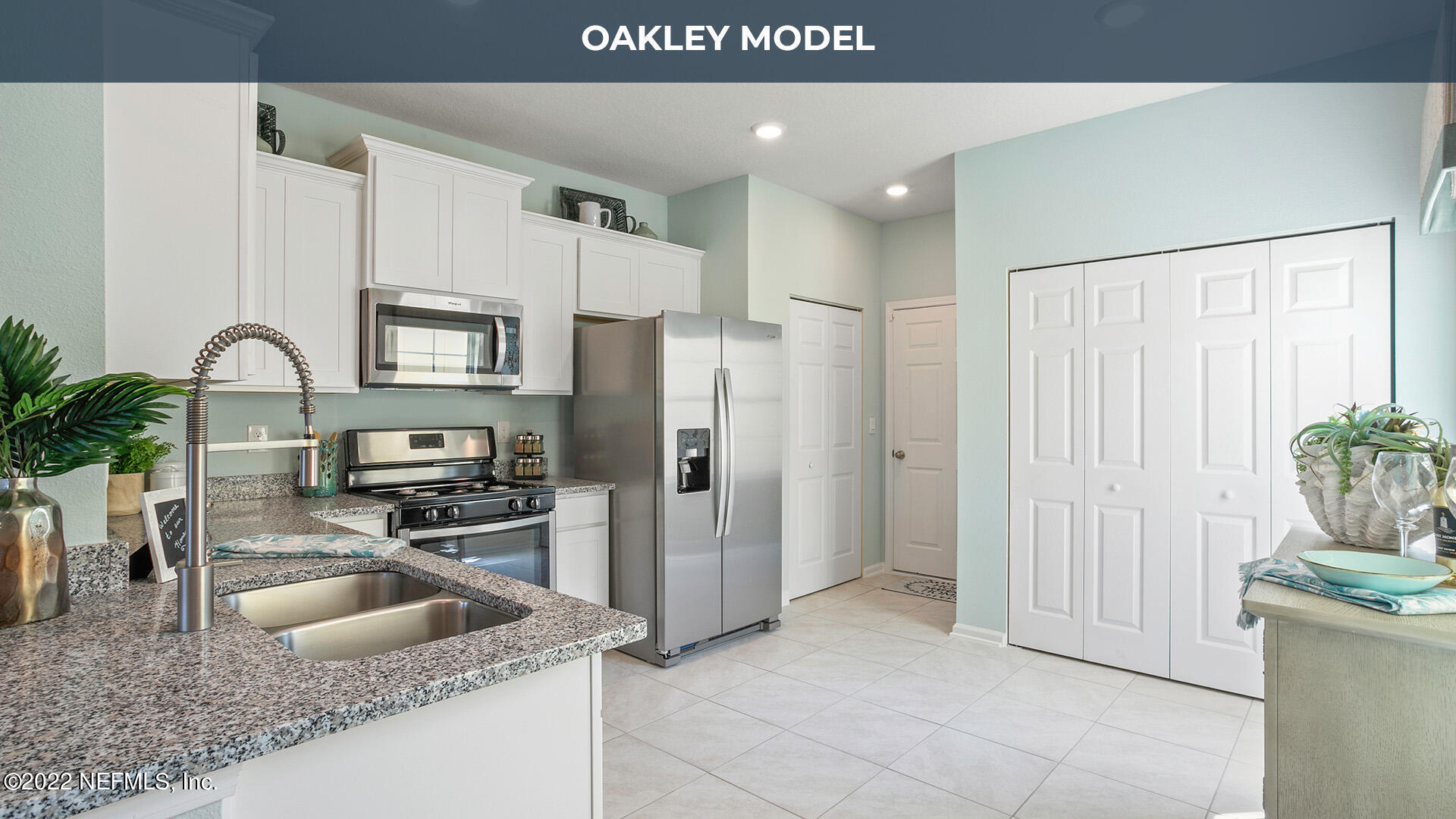 102 Java Lane St. Augustine, FL 32092 - Photo 1 of 31 a kitchen with granite countertop a refrigerator a sink a stove and white cabinets