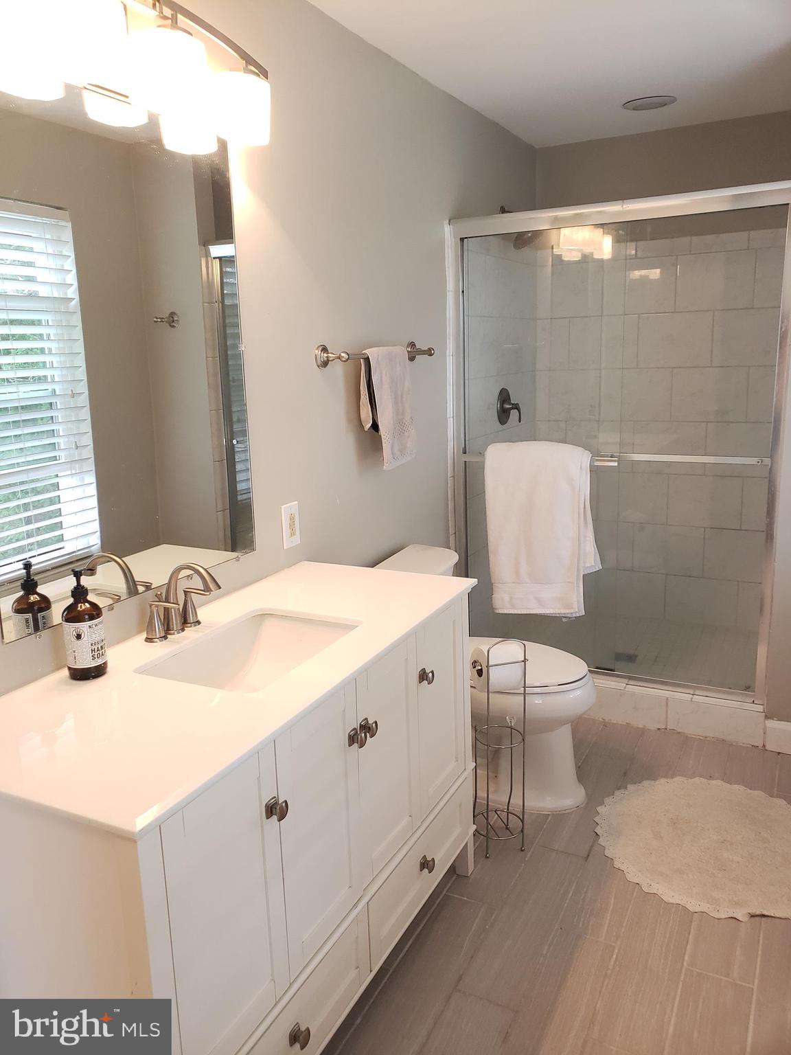 11150 Harbor Court Reston, VA 20191 - Photo 11 of 16 Gorgeous master bath, glass shower, stone floor.