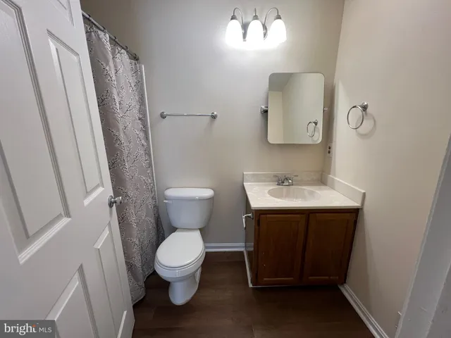 a bathroom with a sink toilet and a mirror