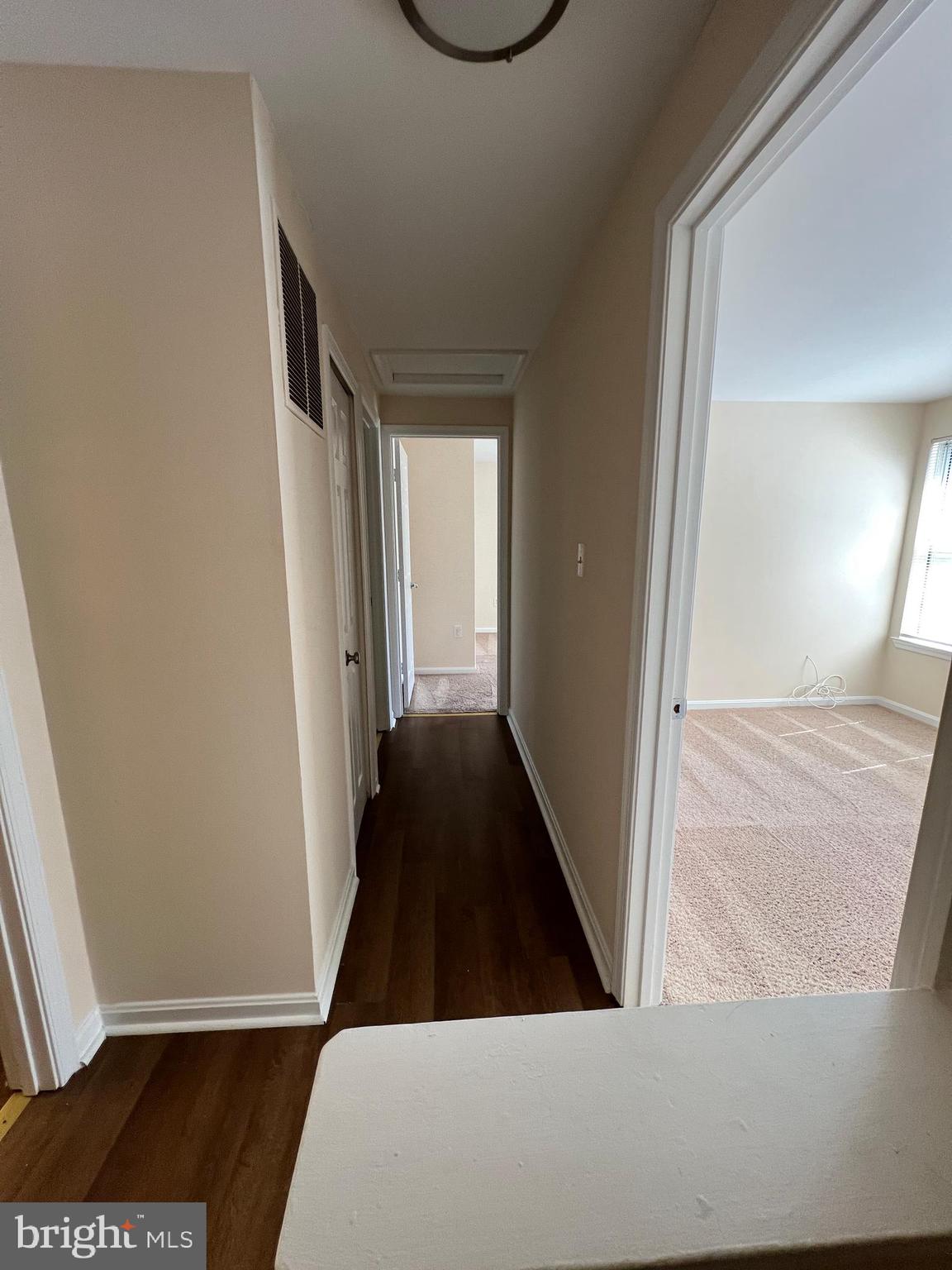 6304 Cheetah Court Waldorf, MD 20603 - Photo 26 of 30 a view of a hallway with wooden floor and staircase
