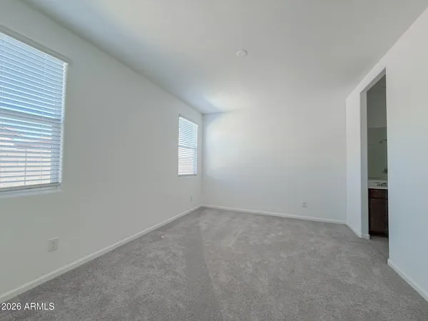 an empty room with windows and closet