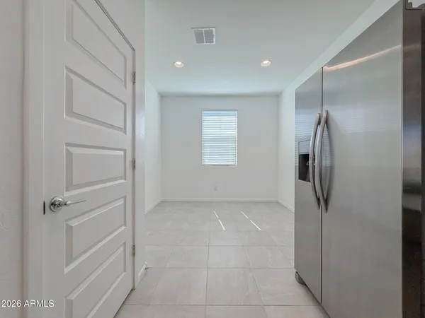 an empty room with a cabinet and mirrors