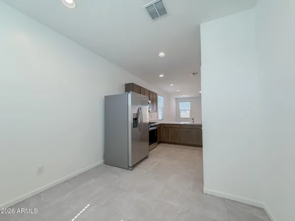 an empty room with a furniture and a ceiling fan