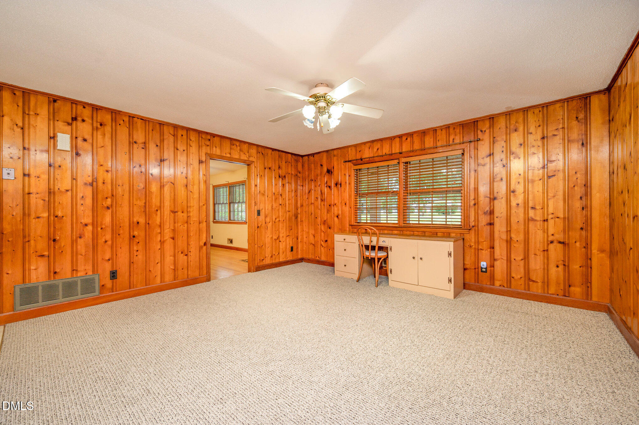 3845 Marsh Creek Road Raleigh, NC 27604 - Photo 7 of 24 an empty room with chandelier fan and windows