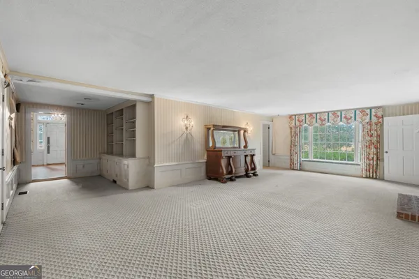 a big room with closet and a large window