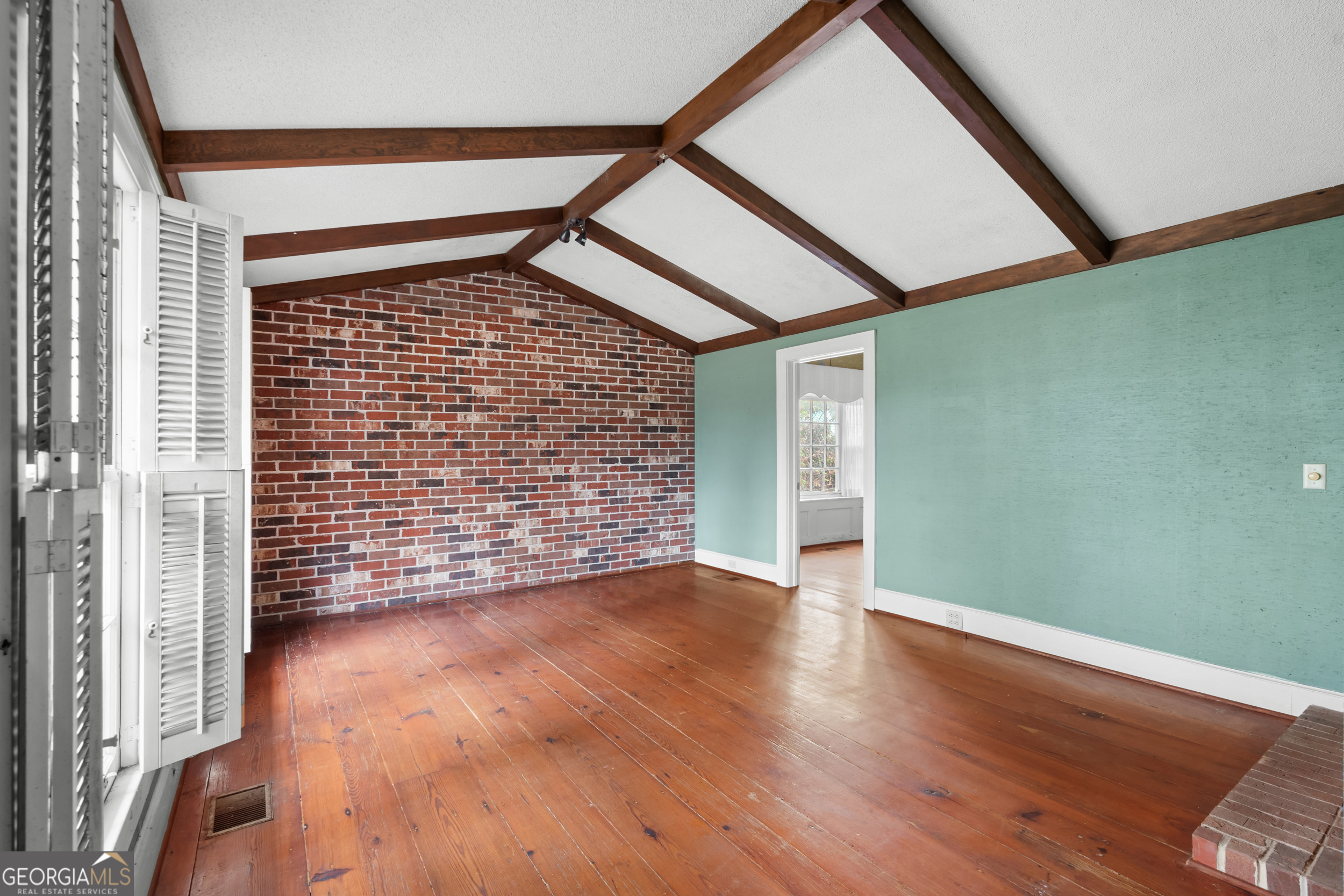 46875 Highway 46 Metter, GA 30439 - Photo 13 of 45 a view of an empty room with wooden floor and a window