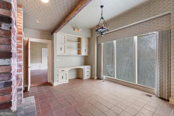 a view of a livingroom with a chandelier and refrigerator