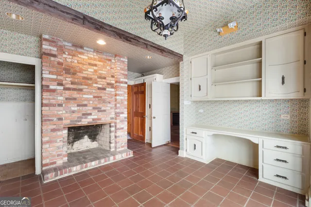 a kitchen with white cabinets and a fireplace