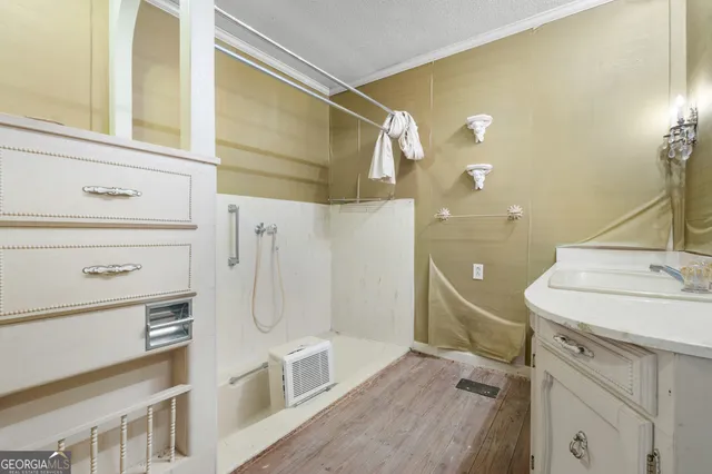 a bathroom with a sink mirror and shower