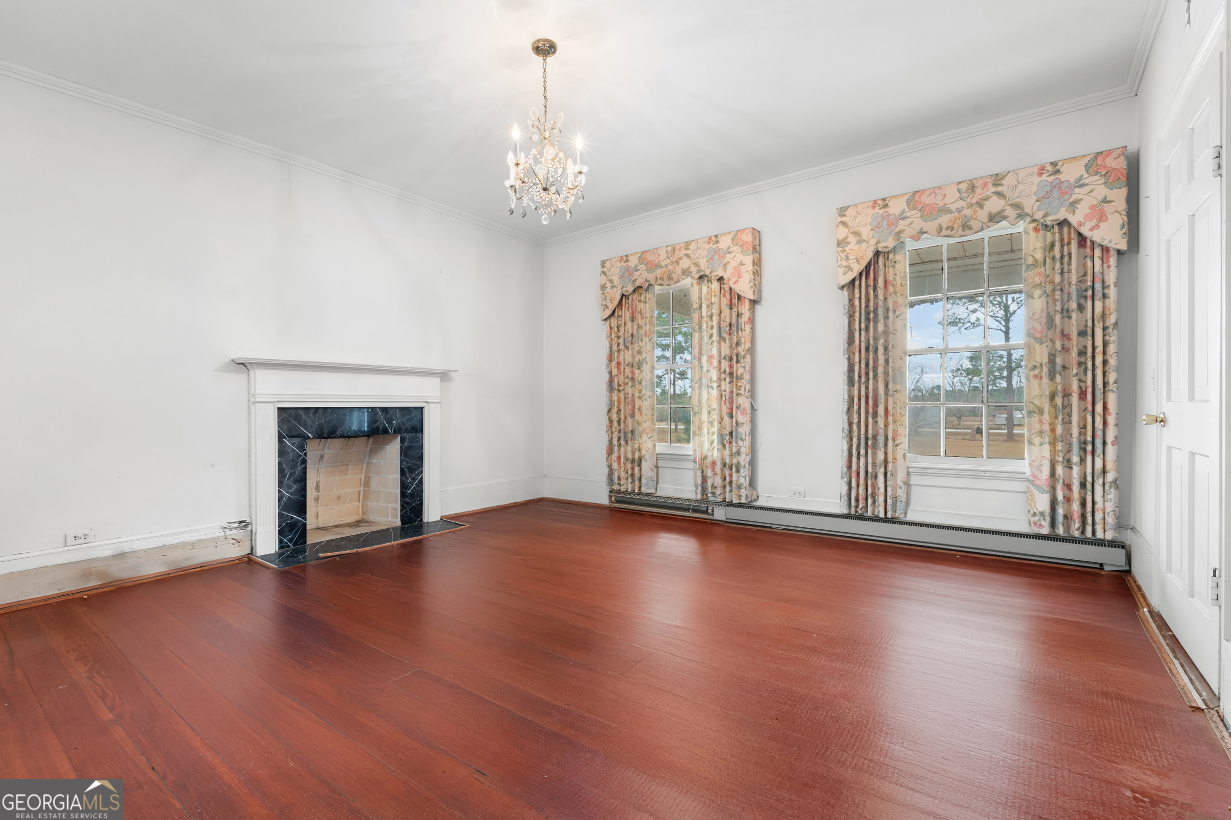 46875 Highway 46 Metter, GA 30439 - Photo 29 of 45 a view of an empty room with wooden floor and a window